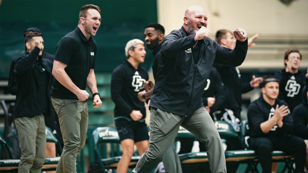 Jon Sioredas pumping both fists, celebrating with his team